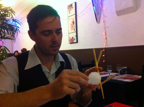 Gregory demonstrating the movement of phages through mucus, with the assistance of three chopsticks and a prawn cracker, over dinner at Fuji Yama