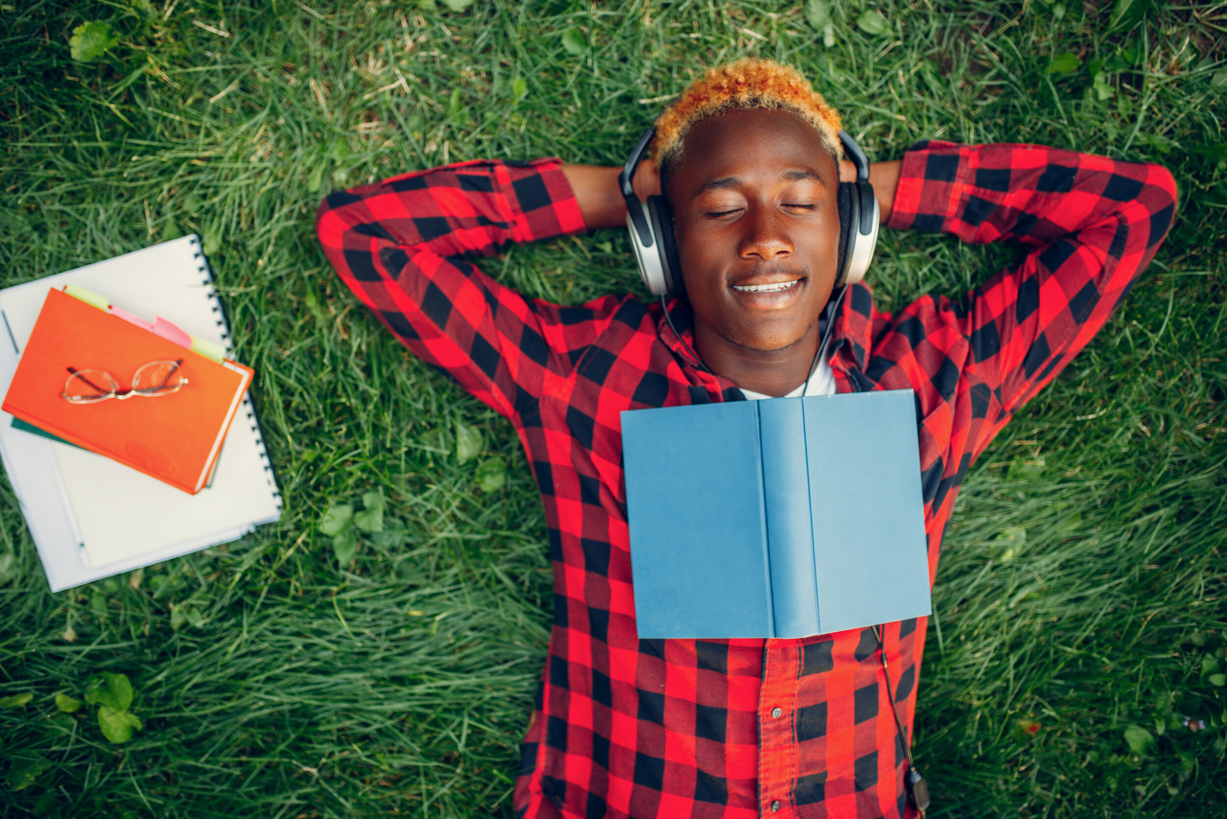black-student-resting-on-the-grass-top-view-EFDLJUW.jpg