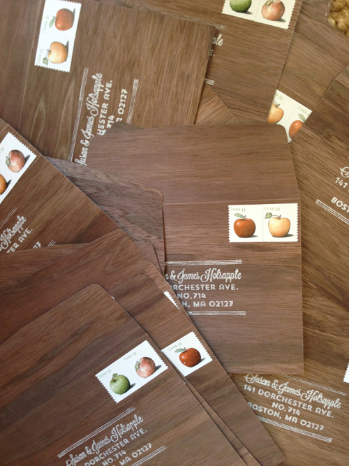  One element that tied together the pretty distant looks of the save the date and invitation were the walnut wood reply envelopes. Rubber stamped with return address in white and postage stamped with apples.&nbsp; 