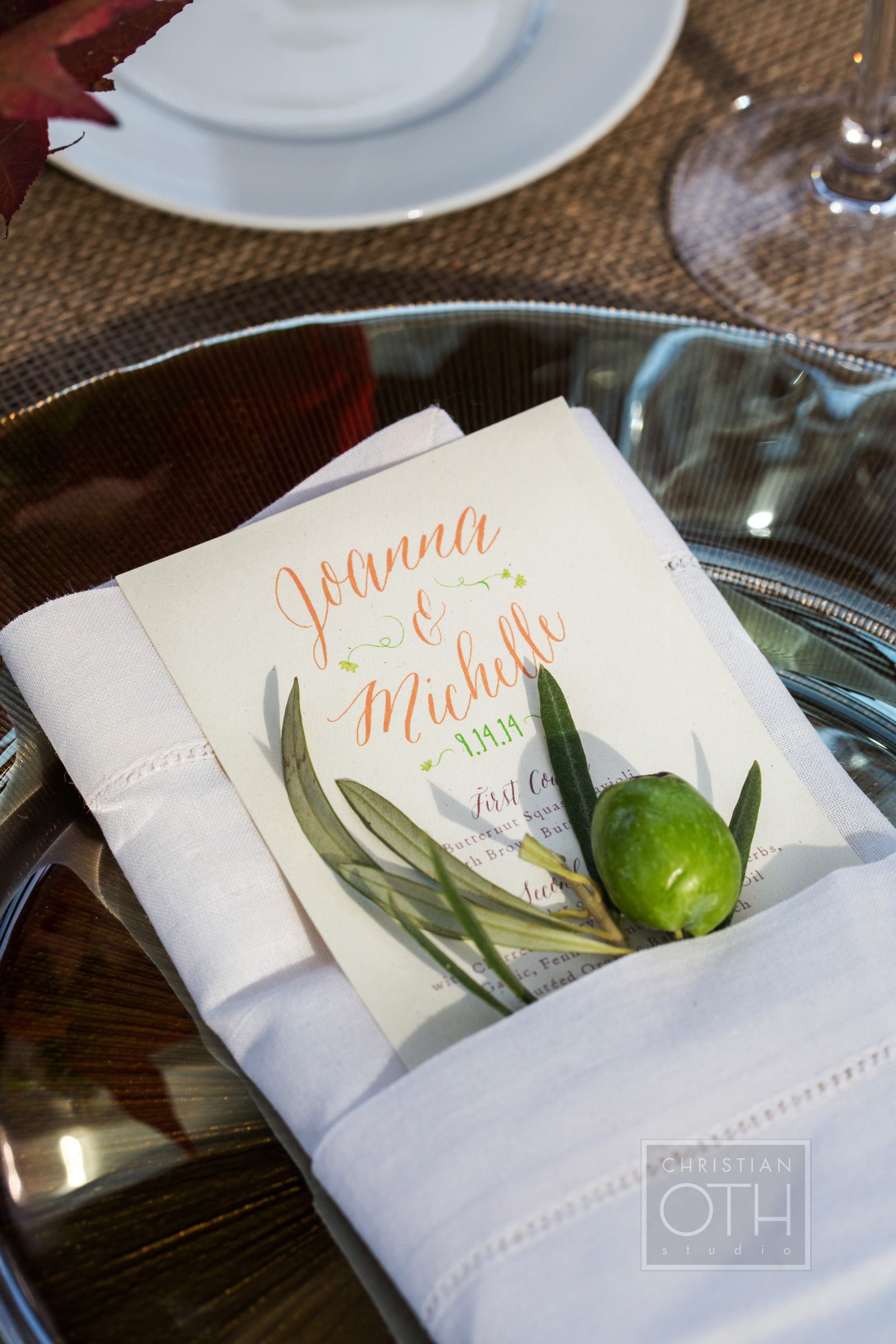  Other day of pieces include a menu cut to fit inside a folded napkin and simple flat place cards which were pinned to olive branches for display.&nbsp; 
