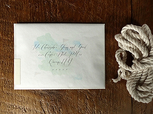  A simple folder printed with the couples names&nbsp;is nestled inside a transparent vellum envelope. A map of Newport printed on the back of the folder can be seen through the envelope&nbsp;behind the address.&nbsp; 