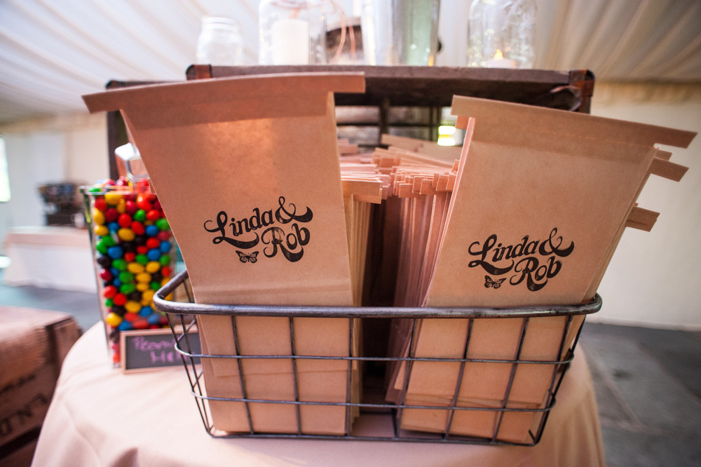 Tin tie bags stamped with the couple's logo were provided for the expansive candy bar. Additional photography provided by Shari Silk of Silk Studios 