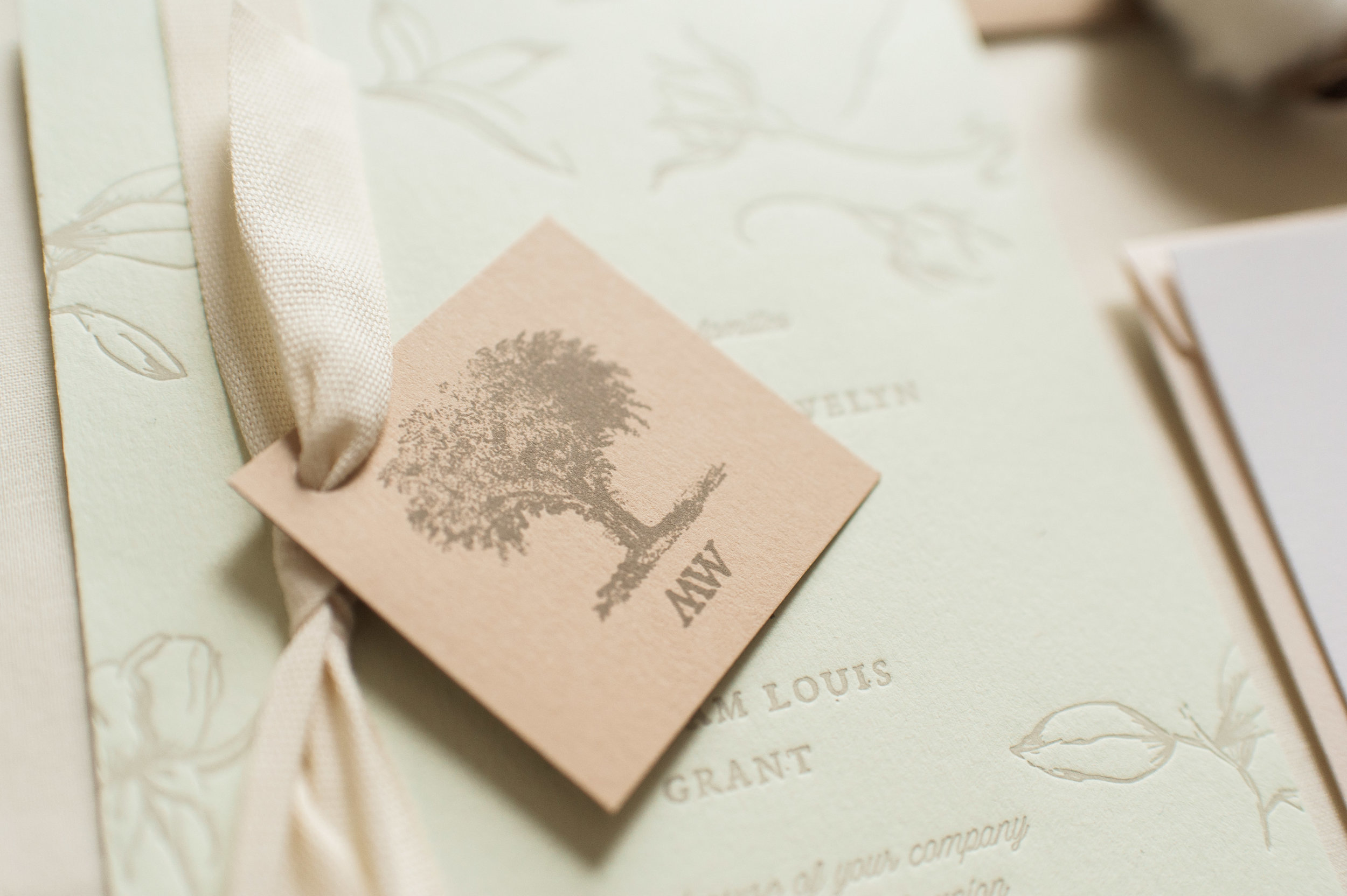  Sheffield has a "Big Elm" tree in the center of town so we created a logo and monogram tag, tied to the invitation with an understated cotton twill ribbon.&nbsp; 