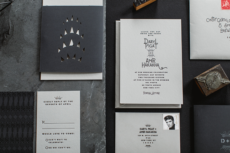  Daryl and Amir favored a monochromatic color palette in shades of gray and black. We created a folder out of rubberized paper with a laser cut peek-a-boo likeness of the top of the Chrysler Building to wrap around the cards.&nbsp; 