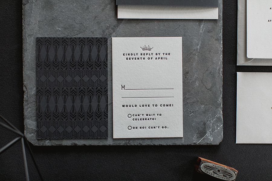  We duplexed the reply card with the same black rubberized paper we used for the folder and printed a custom art deco pattern with clear gloss for a very subtle effect.&nbsp; 