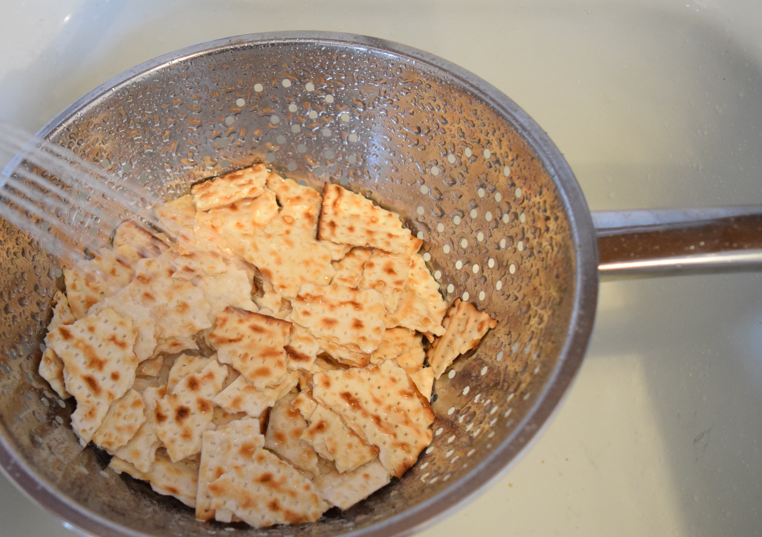 Soak broken up matza under cold water. 