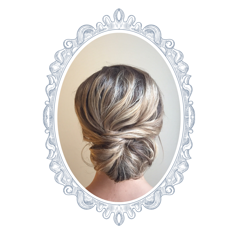 Back view of a woman's short, styled blond hair in loose waves, in an oval mirror reflection.