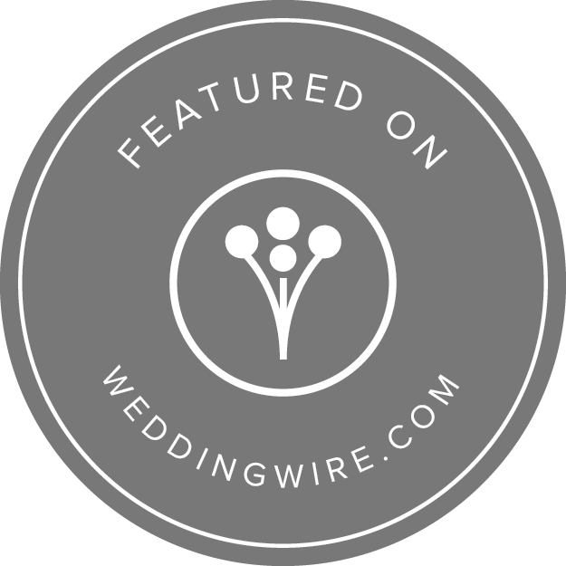 Grey circular badge with white text and design, stating 'Featured on weddingwire.com', with a central floral graphic.