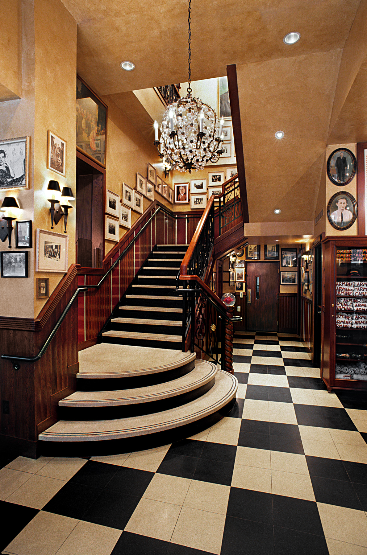 Carmine's Italian Restaurant. Tobin Parnes Design. NYC. Hospitality Design. Restaurant. Times Square. Black & White. Checker Board. Flooring. Millwork. Staircase.