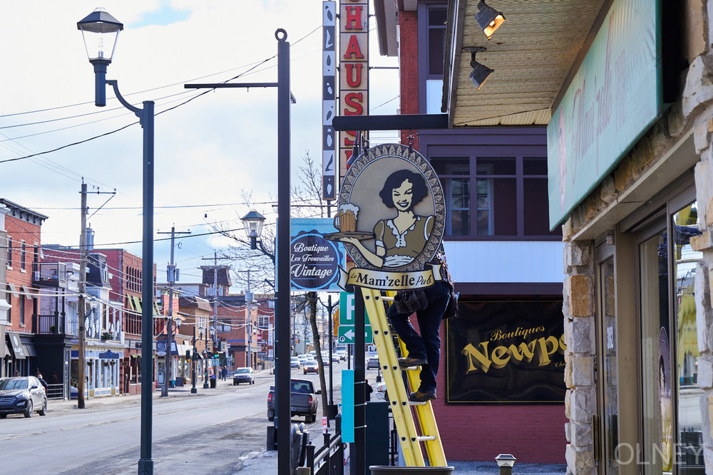 downtown Magog QC - Man on a ladder