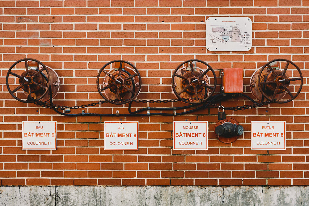 hydrants valves on factory wall