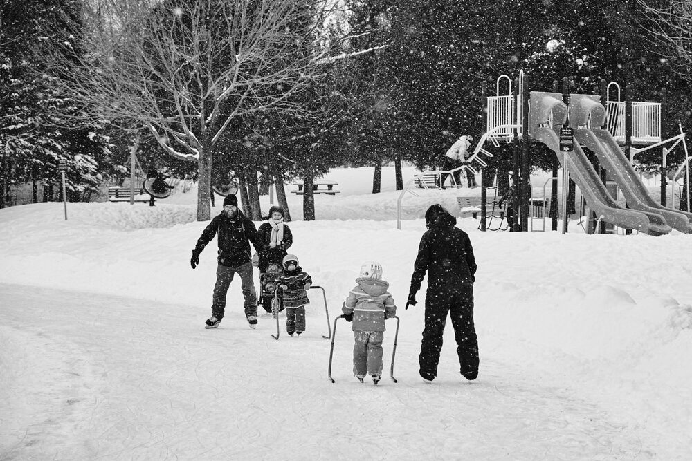 family with children learning to skate