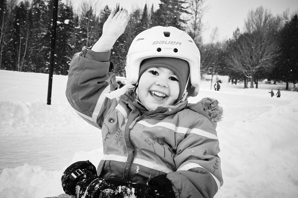 young girl waving at the photographer