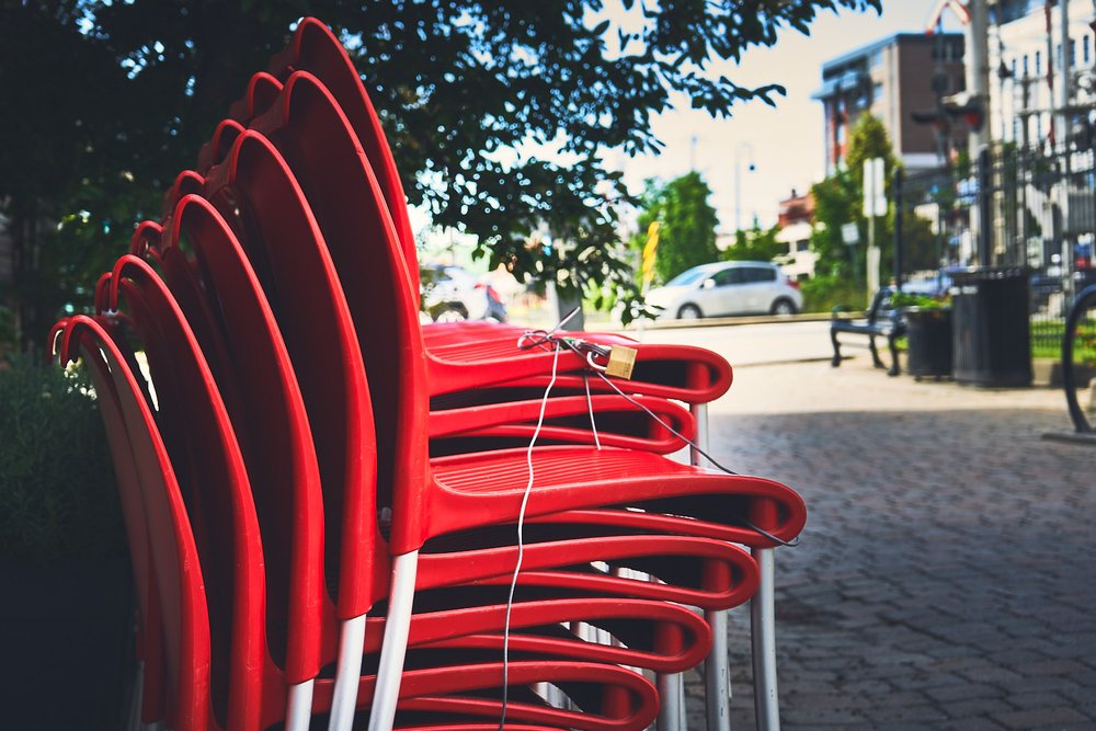 stacked red chairs at Pizzicato, Sherbrooke, QC, Canada