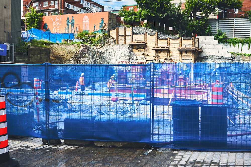 workers behind blue fence in downtown Sherbrooke, QC, Canada