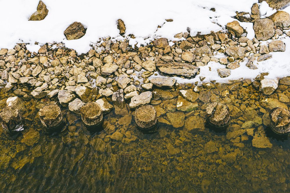 pillars from a temporary promenade are rotting in Lake Massawippi in North Hatley QC Canada