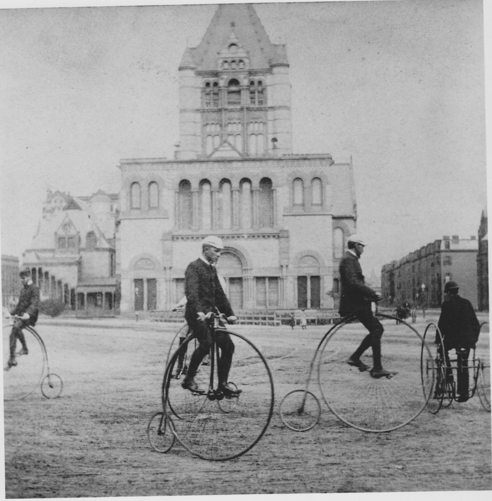   High-wheel or “ordinary” riders, along with a tricyclist, take a turn around Copley Square in Boston, Massachusetts, about 1880. &nbsp;National Archives RG 306 PS D (61–10196).  