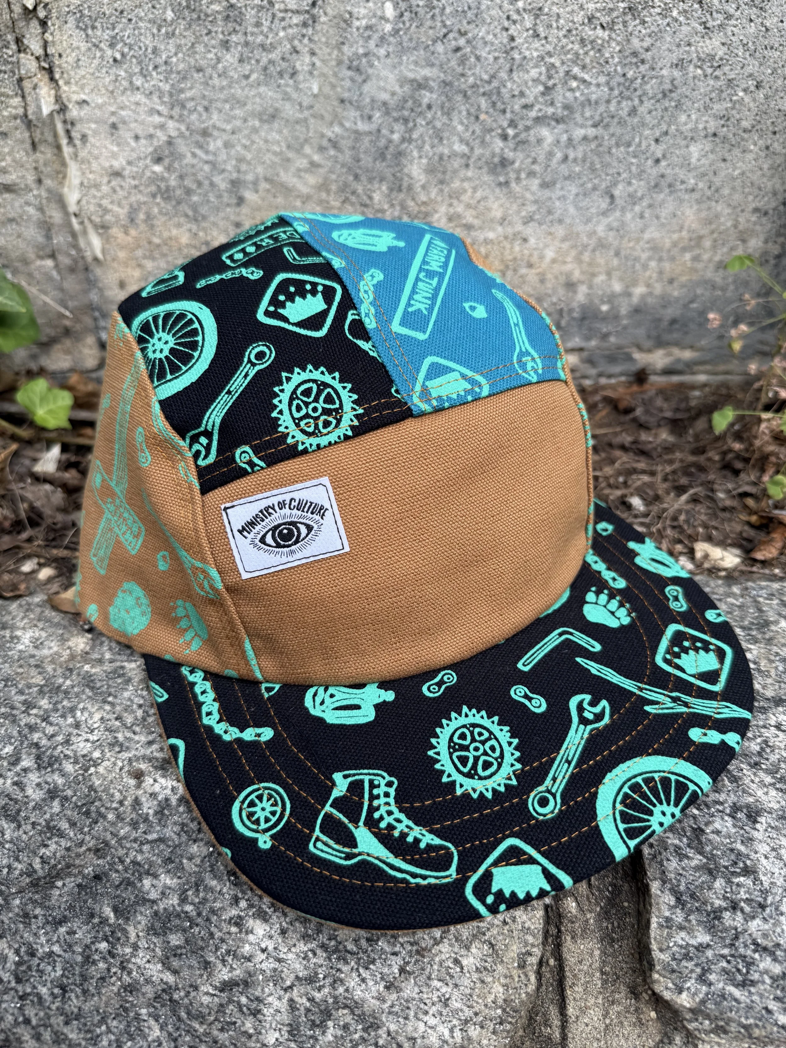 Kingdom Trails Hike and Bike Print 5 Panel Hat in Black, Turquoise, and Tan