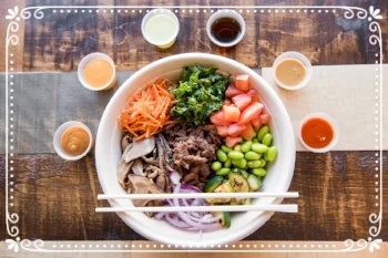 Beef Bulgogi, Shredded Carrots, Kales Salad, Tomatoes, Edamame, Grilled Zucchini, Red Onions, and Shiitake Mushrooms