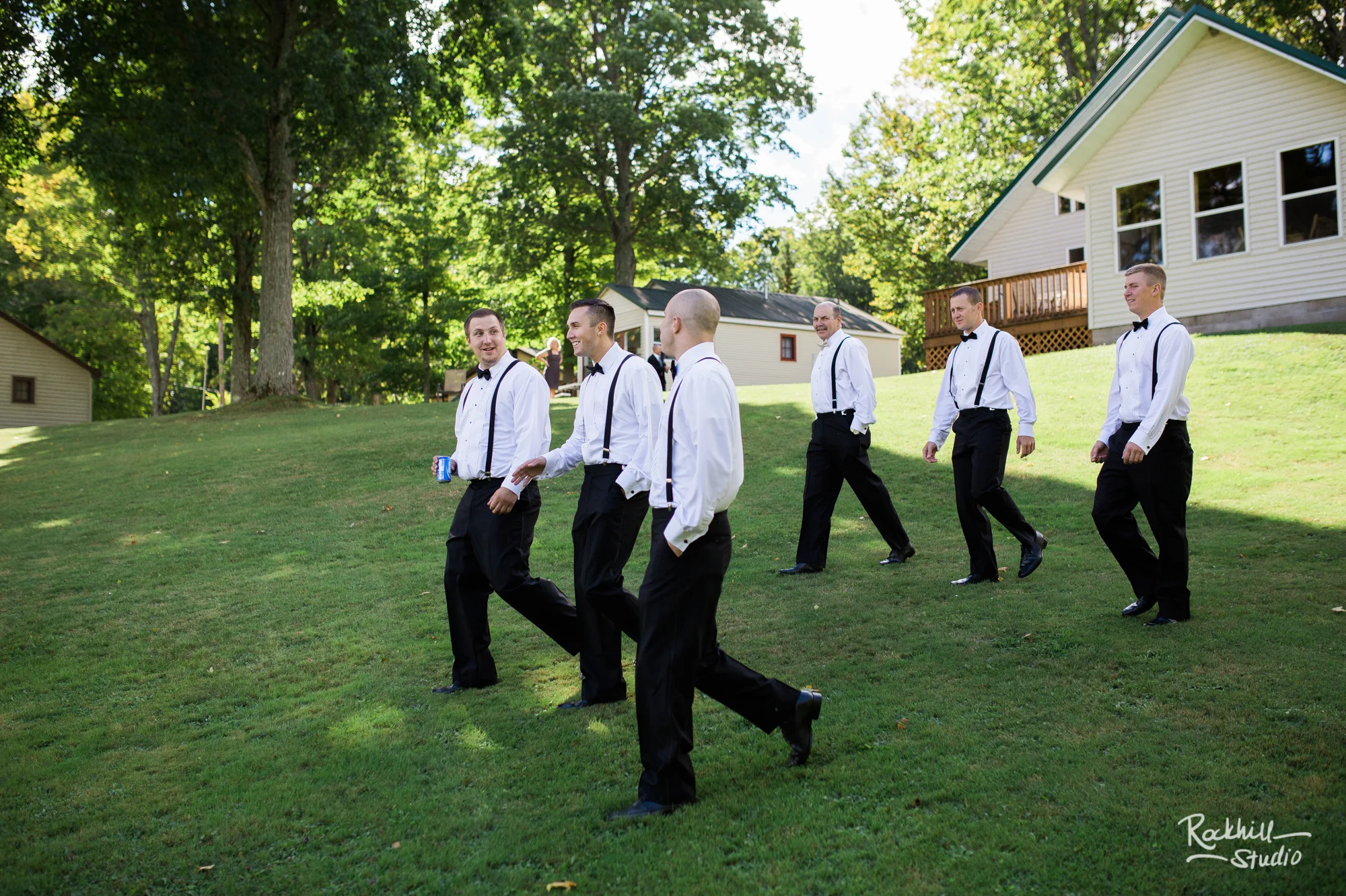 rockhill-studio-newberry-michigan-wedding-groomsmen-walking-fun.jpg
