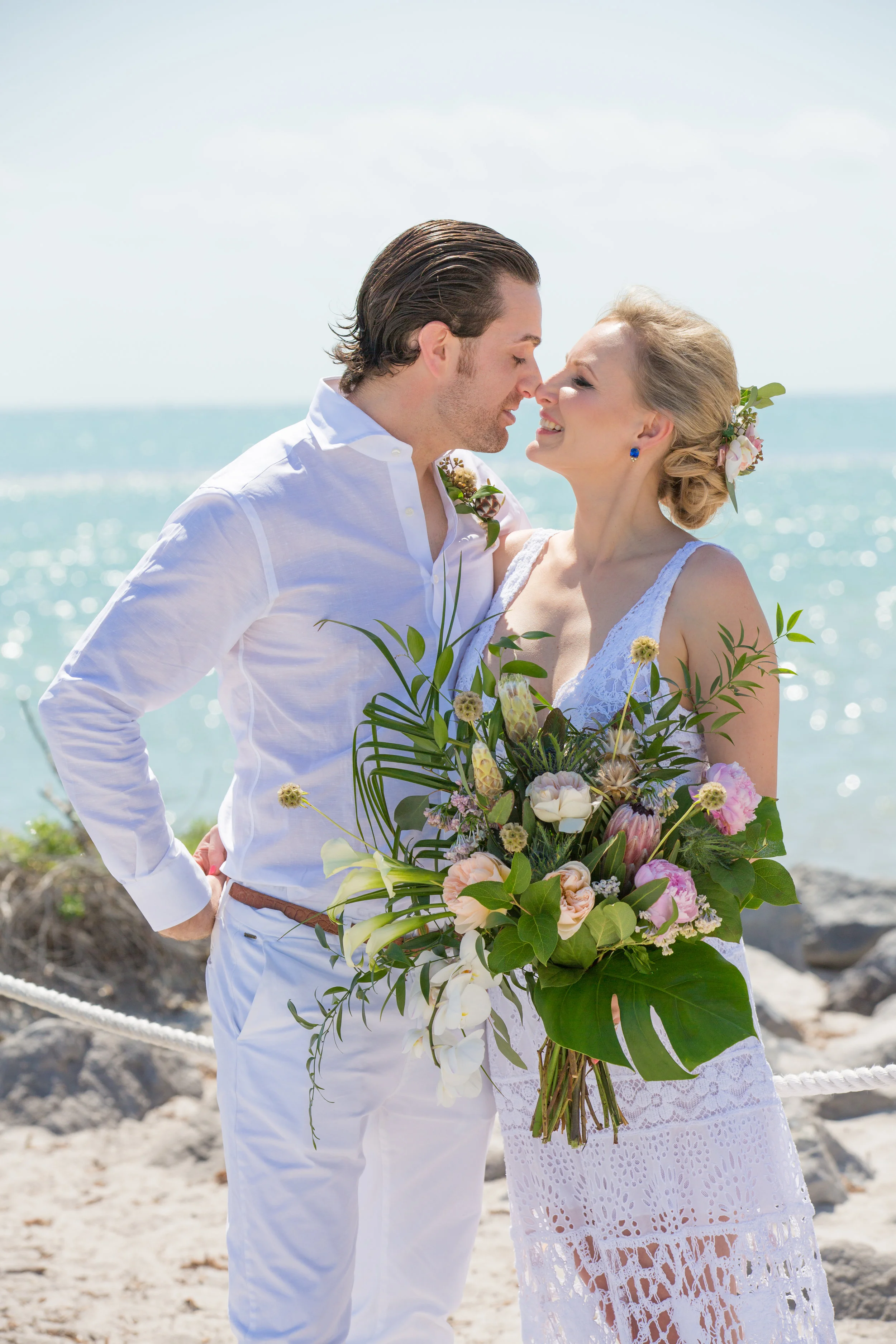 Bride and groom at Key Biscayne wedding with tropical bouquet