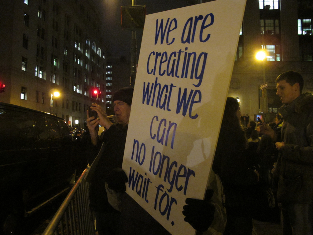 Protestors march across downtown New York to mark the one-month anniversary for Occupy Wall Street.