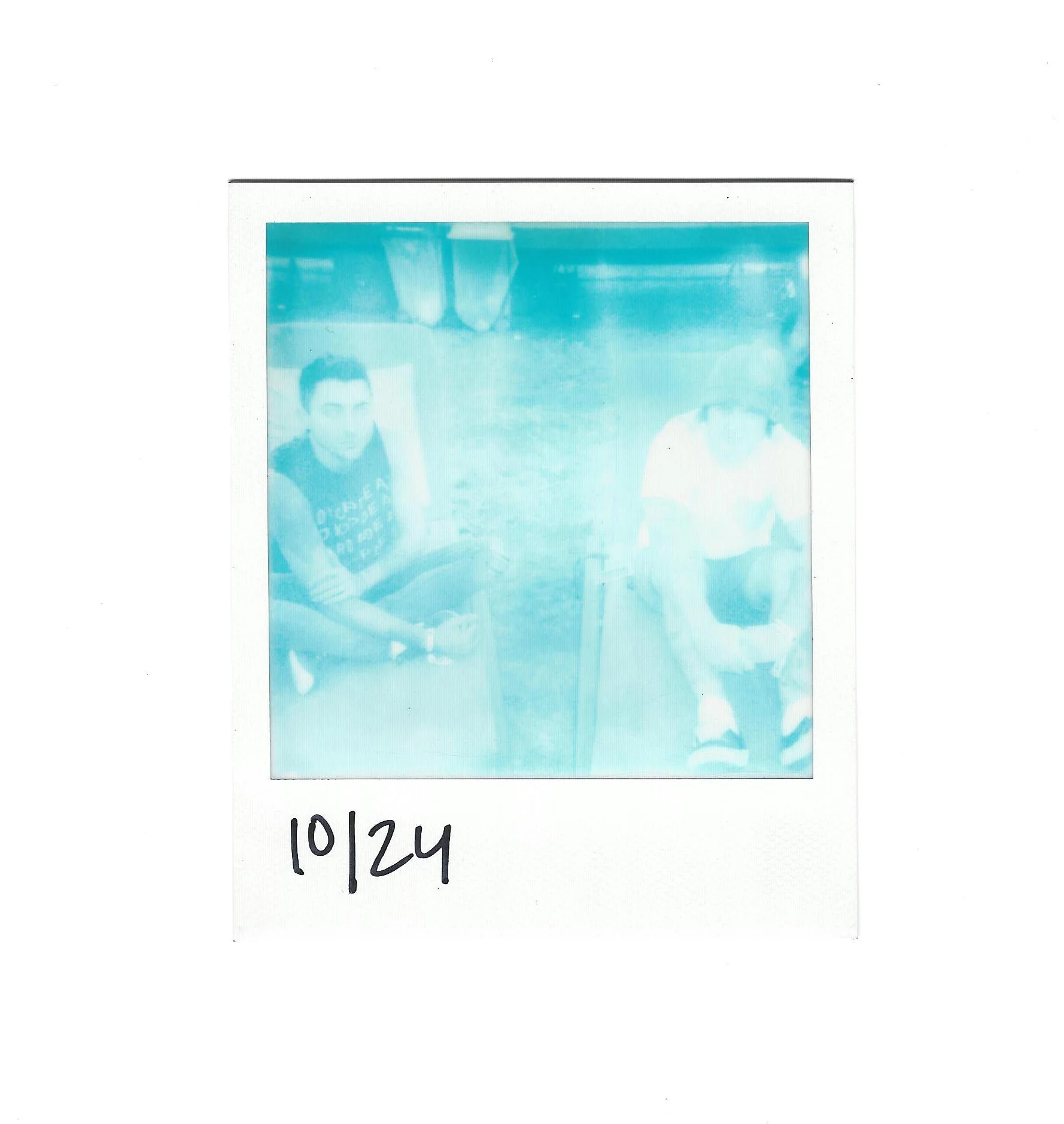 Fish / Malia outside on lawn chairs. Taken on expired impossible monochrome cyan film.
