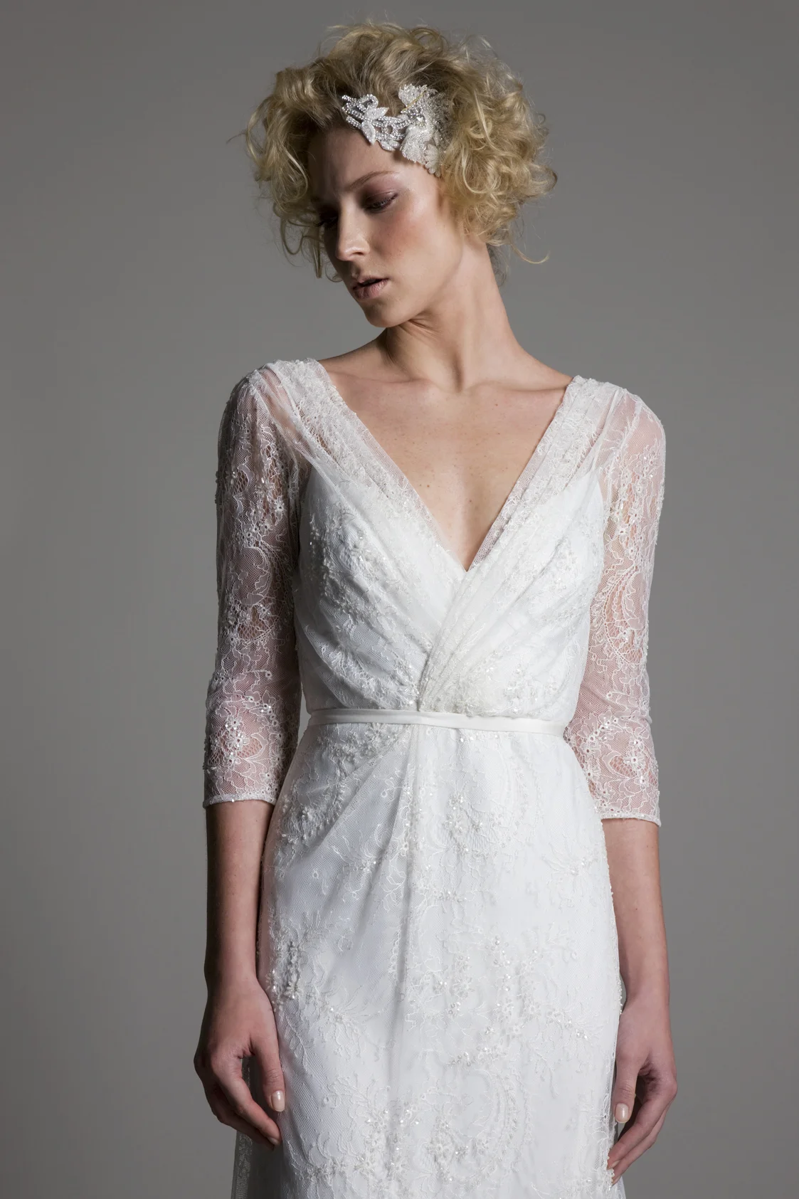 Detailed view of the Josephine wrap front full lace wedding dress with a low V back by Halfpenny London