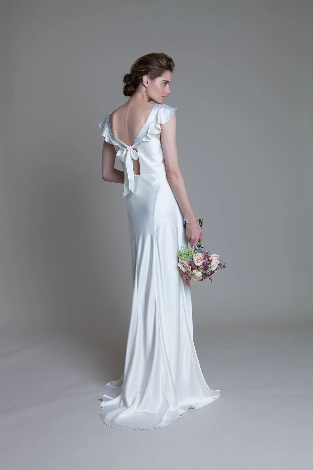 Back view of the Sarah soft cowl neck and empire line bias cut satin bridal wedding dress by Halfpenny London