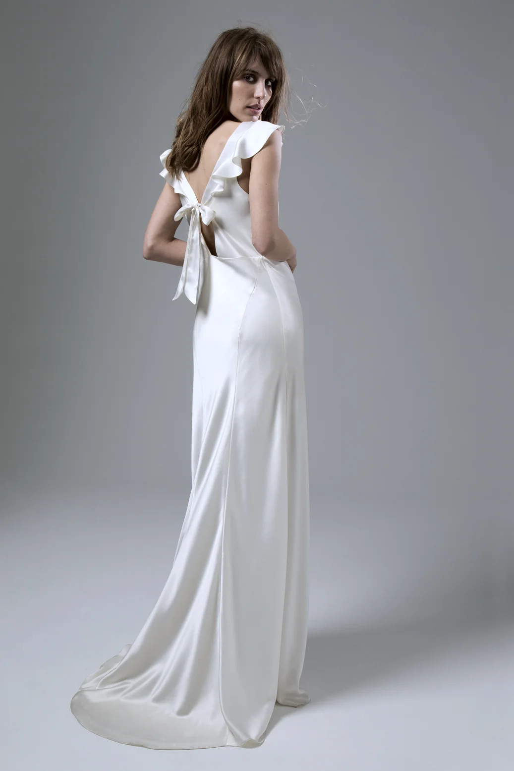 Back view of the Sarah soft cowl neck and empire line bias cut satin wedding dress by Halfpenny London