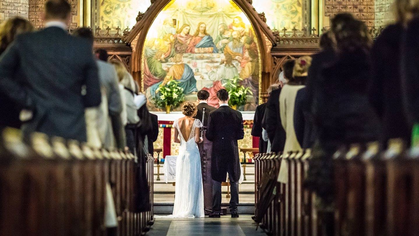 Beautiful bride Alexandra wore the Violet lace wedding dress by Halfpenny London with plunging back, lace cap sleeves and long train