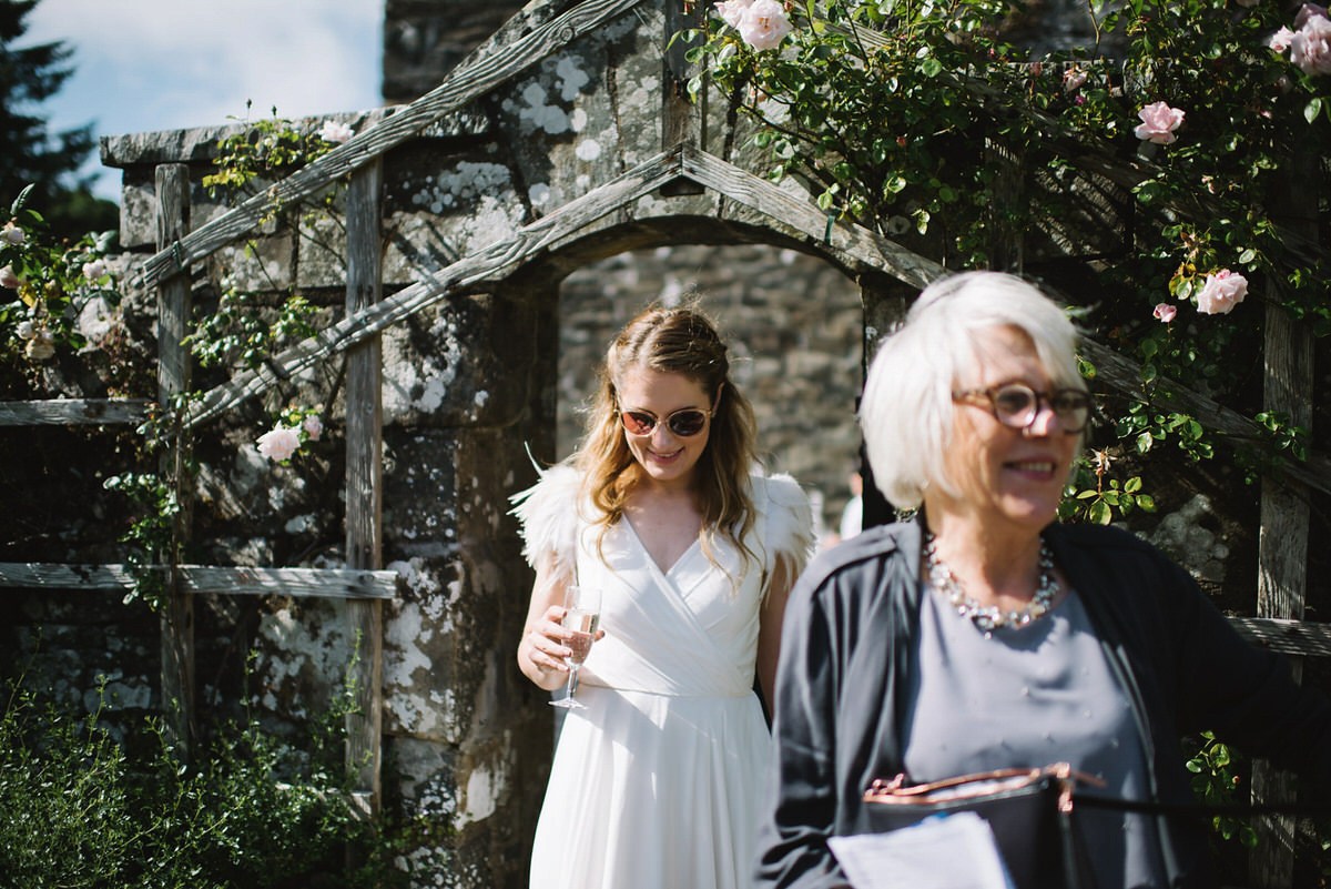 Beautiful Saskia wears a wedding dress by halfpenny London featuring a stunning V back and feather sleeves
