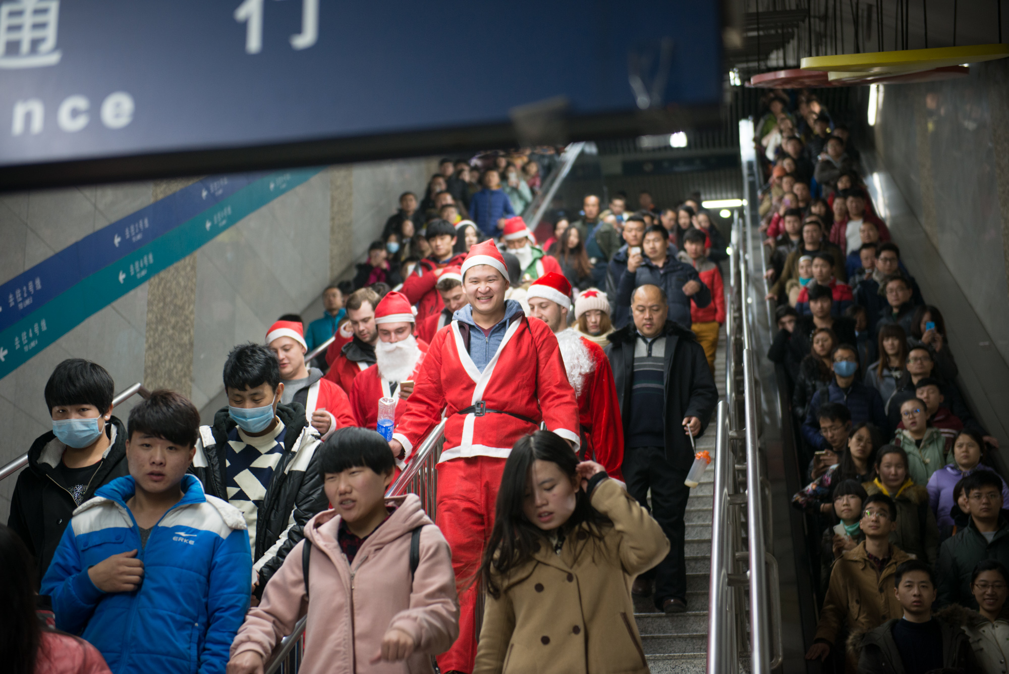 A wave of Santas heads to the Gulou (Drum tower) region of Beijing, on the Line 2 Subway