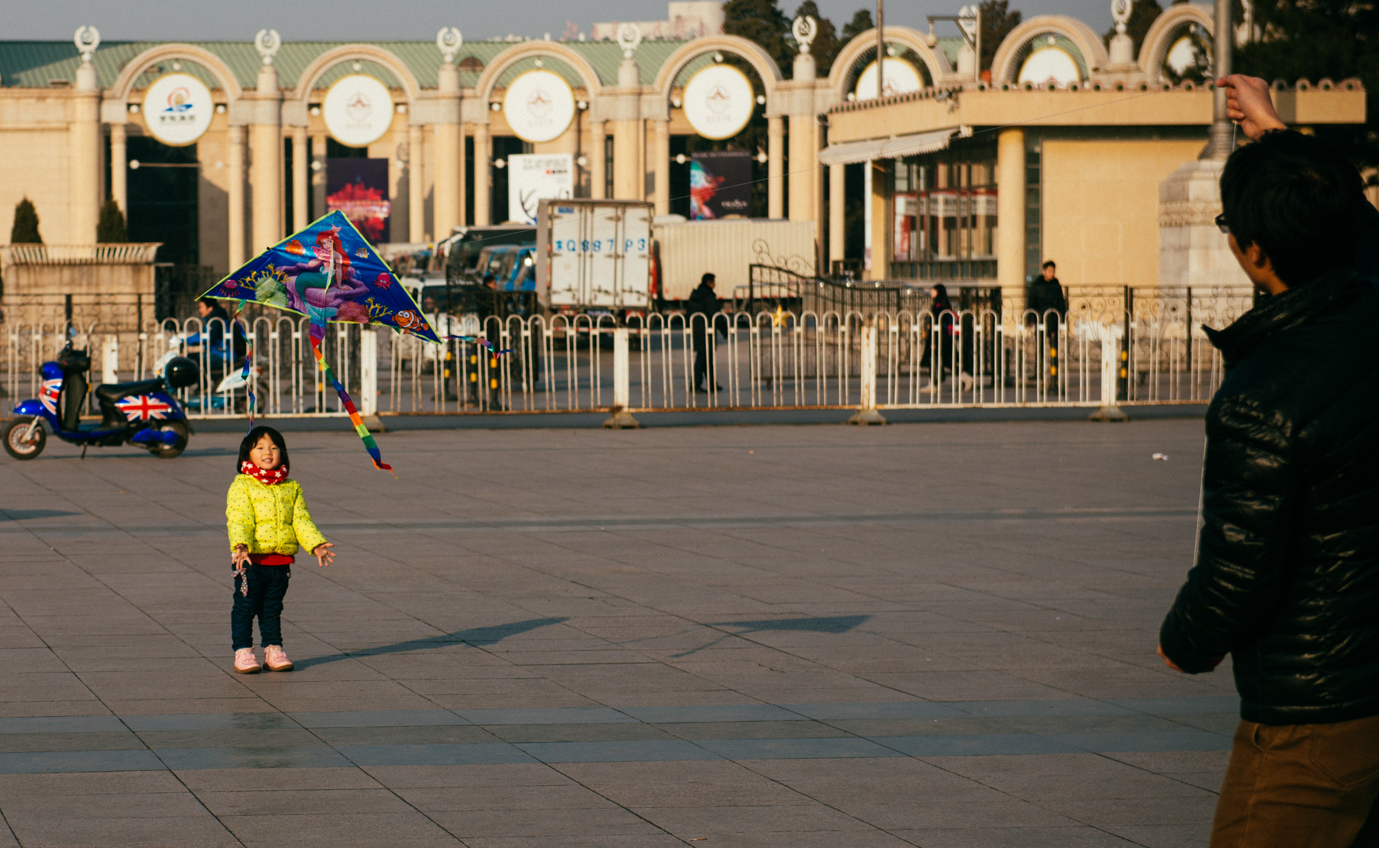 This girl was holding her Little Mermaid kite so her dad could make it fly.