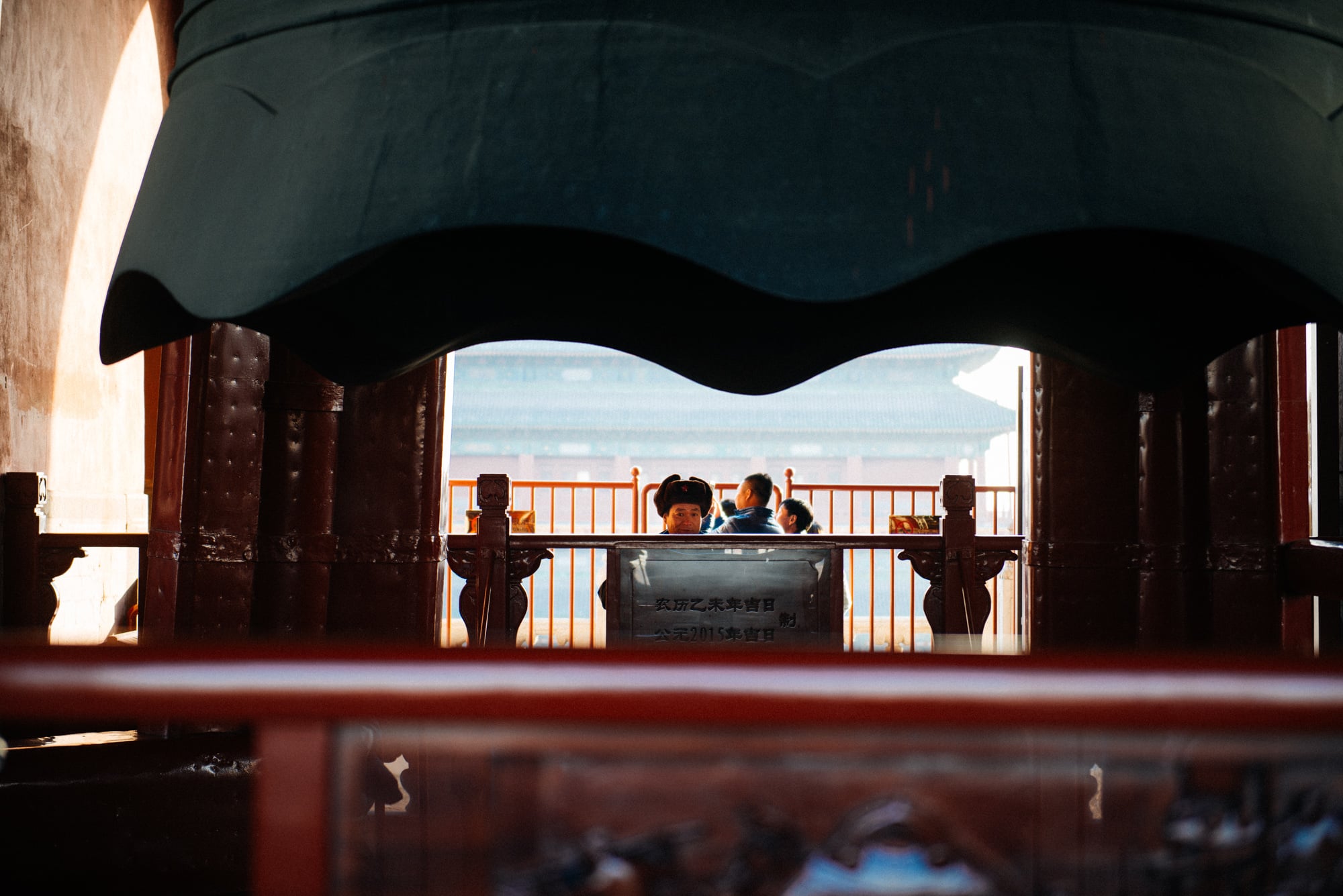 Guard keeps a close eye on us. In the back, the Drum Tower, in the foreground, the bell itself.