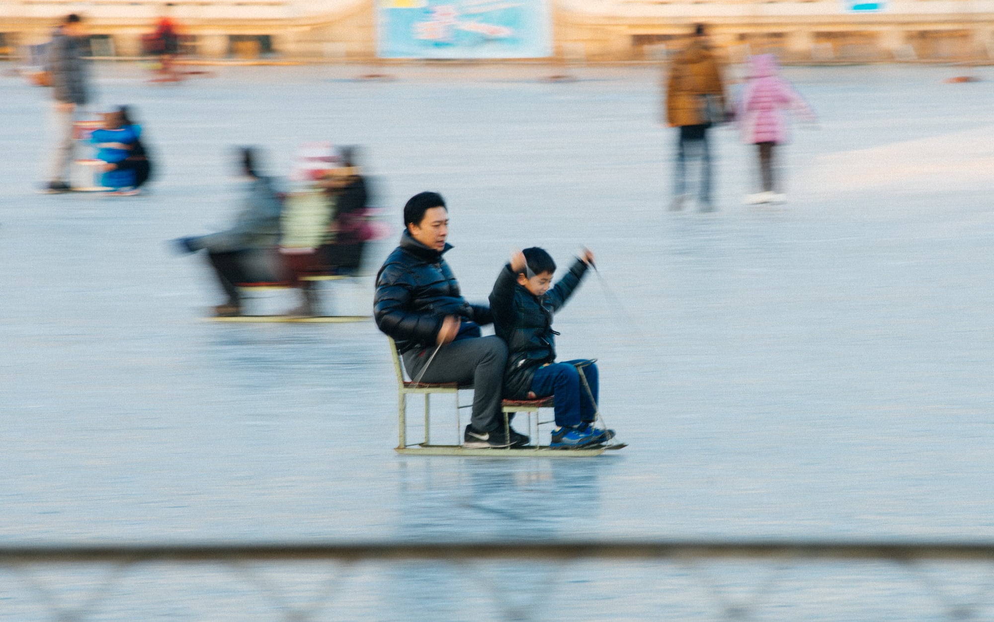 This kid was having so much fun trying to push his chair-skate, but actually the dad in the back was doing all the work.