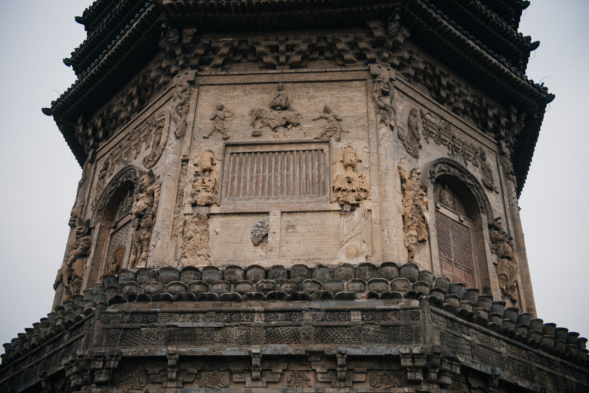According to a local nun, in older times it was possible to go through the doors on the base of the pagoda, but now it's closed down because it's too dangerous. All the (not very extensive) research I have done online indicates that this structure has always been solid and the doors are decorative, but you never know.