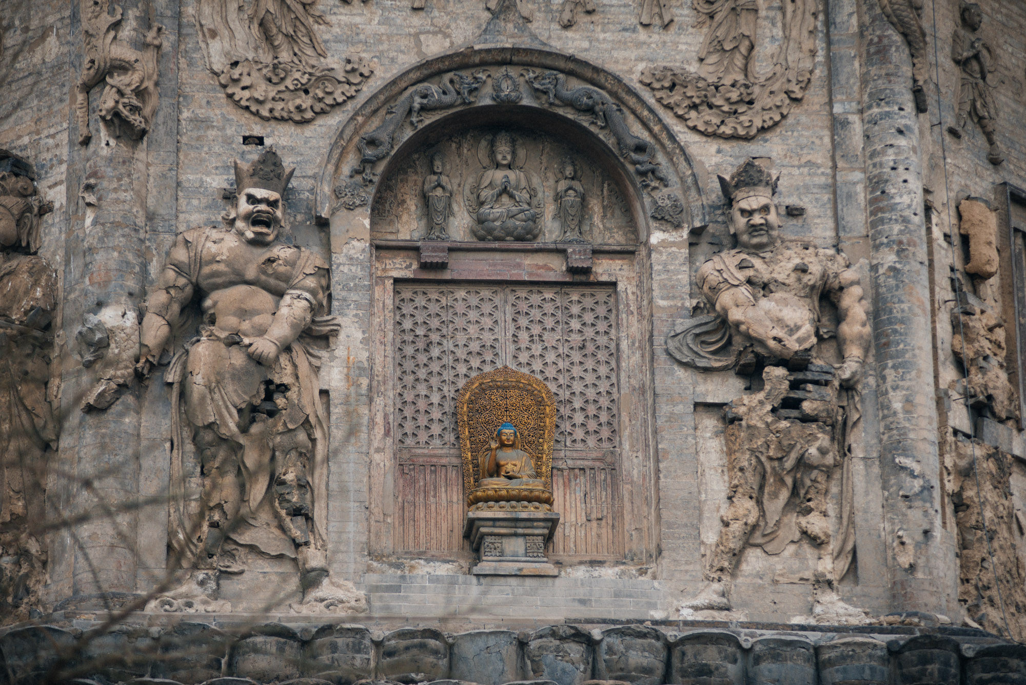 The statues on the sides of the temple, although severely damaged, are believed to be original, having survived the great Tangshan earthquake of 1974 and the Cultural Revolution, when most relics of this and other temples around China were destroyed.
