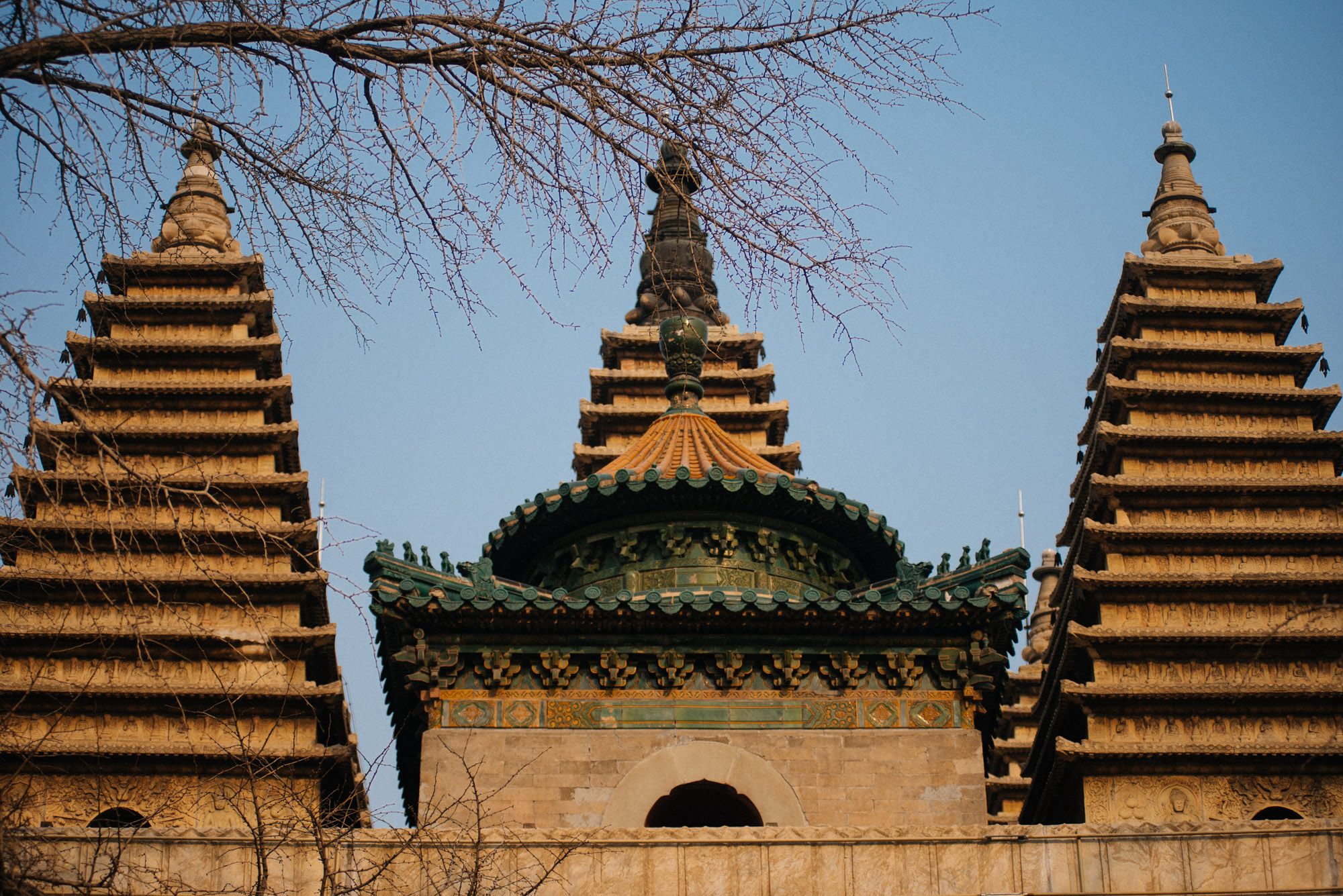 The temple has five pagodas on the top, associated to each of the five Dhyani Buddhas. In the front, with the green tiles, is a Chinese style construction, adding to the uniqueness of this building.