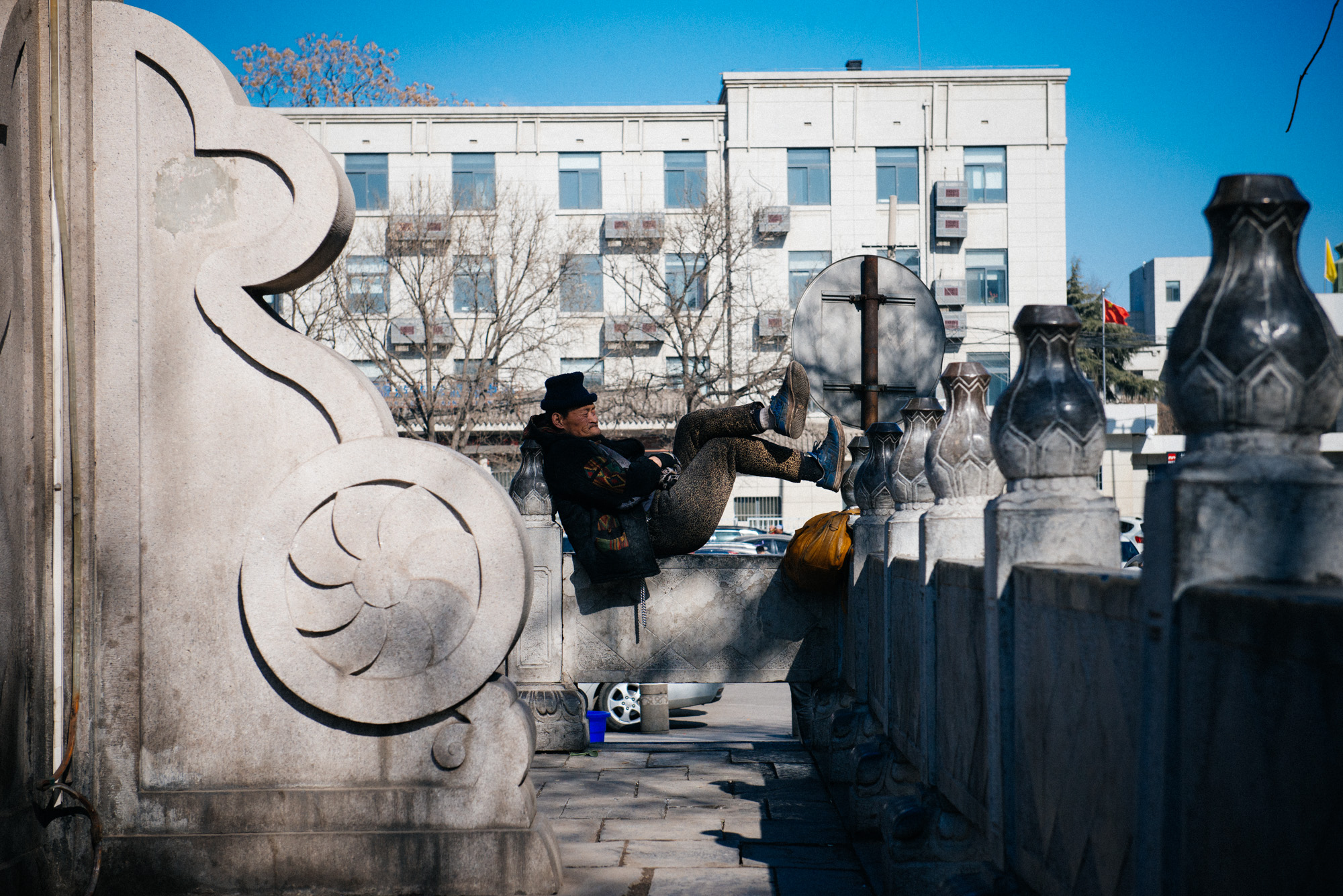 At one end of the Muslim Quarter, a homeless man rests on the walls of a monument. There were a lot of homeless people in Xi'an, way more than Beijing.