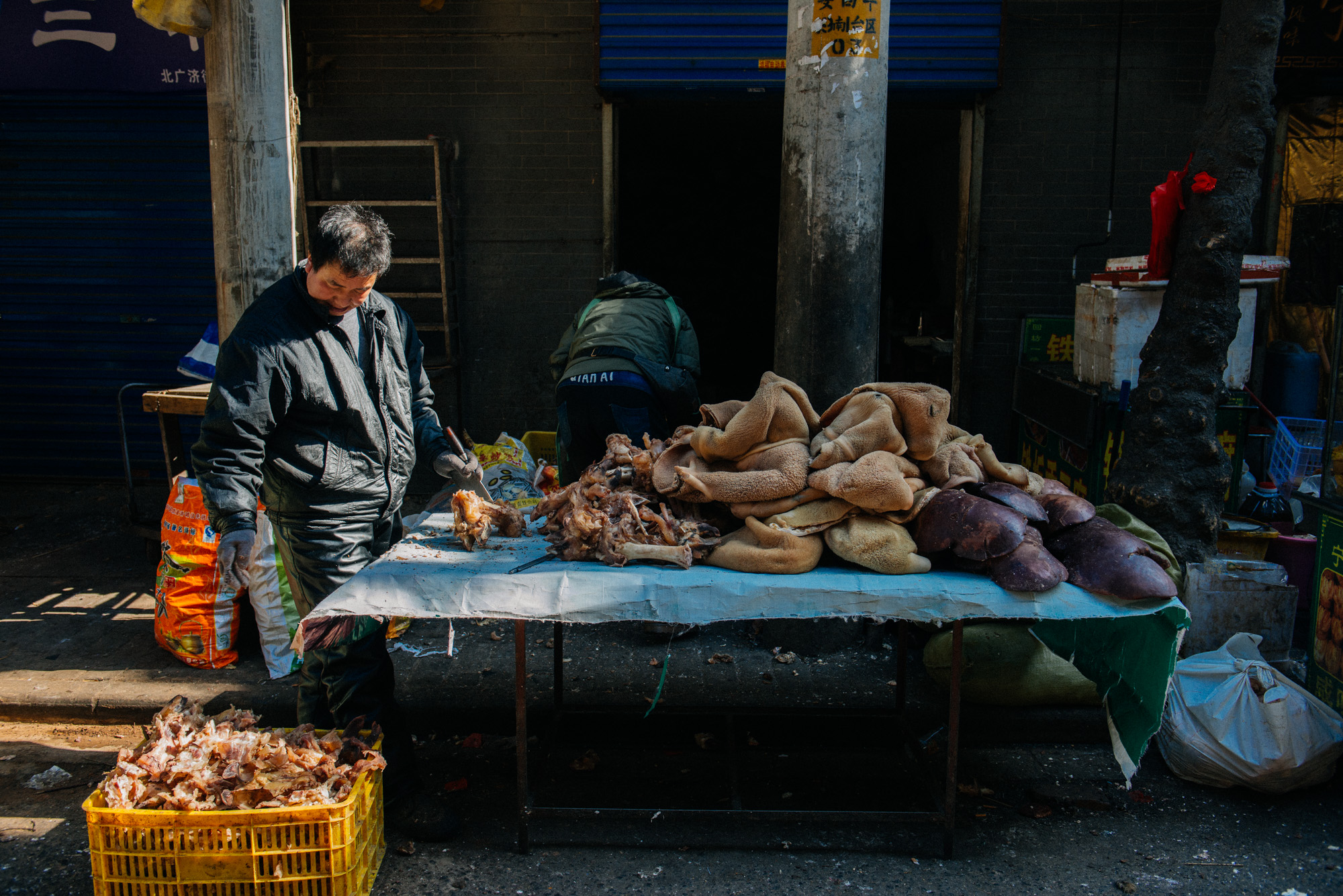 Butcher cleans up cow stomachs which will be later used in stews and sold on the street. The smell in this area was stomach turning. It was a mixture of smoke from the nearby skewer barbecue stands, oil from the nearby fry *insert animal part* stands and, well, dead animals.