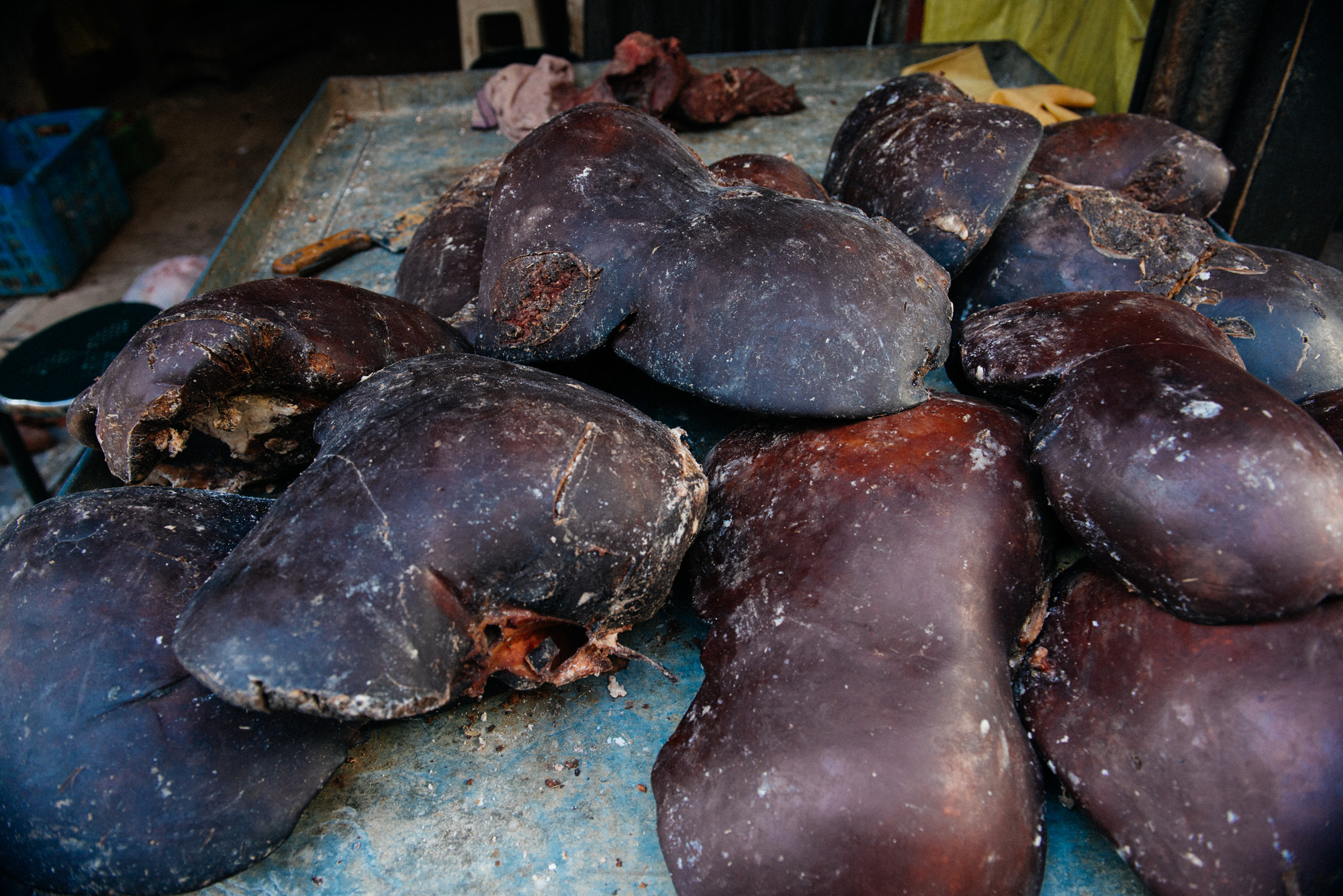 Recently butchered cow livers lie on the counter waiting to be purchased. Hygiene is not a strong feature in parts of town.