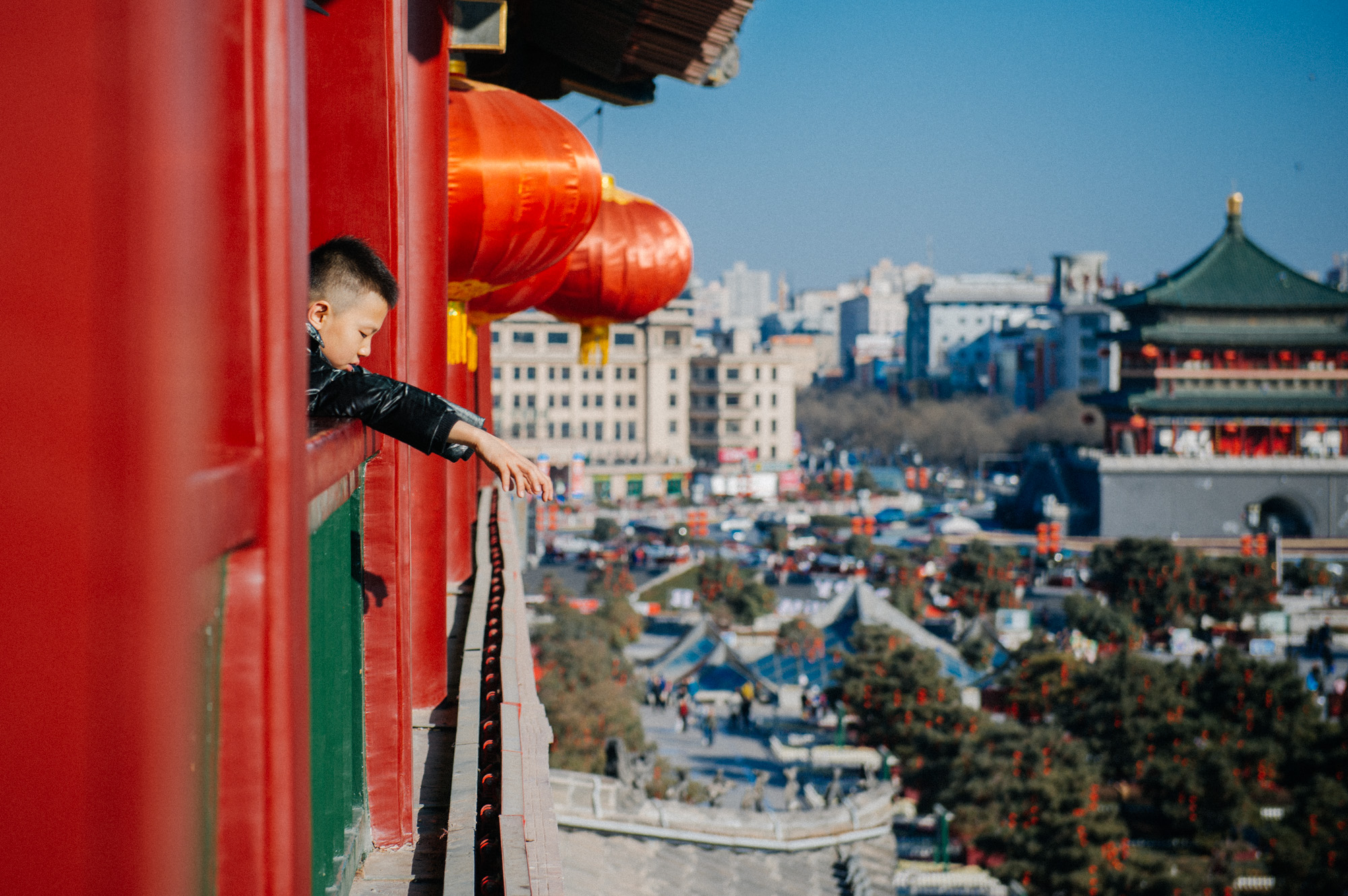 Boy looks down from the third floor of the Drum Tower. If you were wondering if the red lanterns are a seasonal decoration for the Chinese New Year, I can assure you that they are not. Even if you visit Xi'an during the summer months, you will be able to take a picture of the tower decorated with dozens of beautiful lanterns.