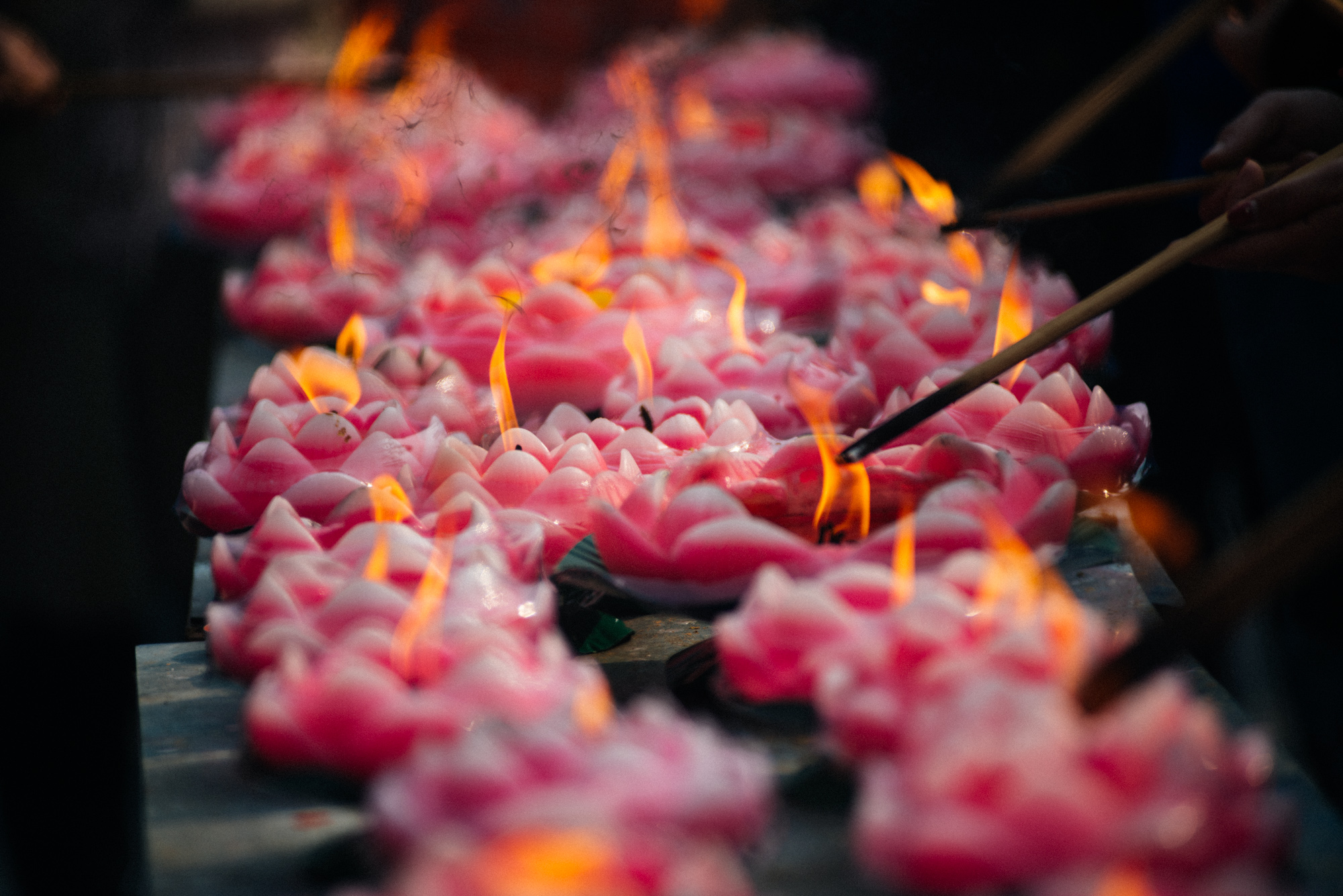 The temple was specially busy on the first days of the Lunar New Year. Worshipers light incense and say their prayers facing a big Buddha statue.