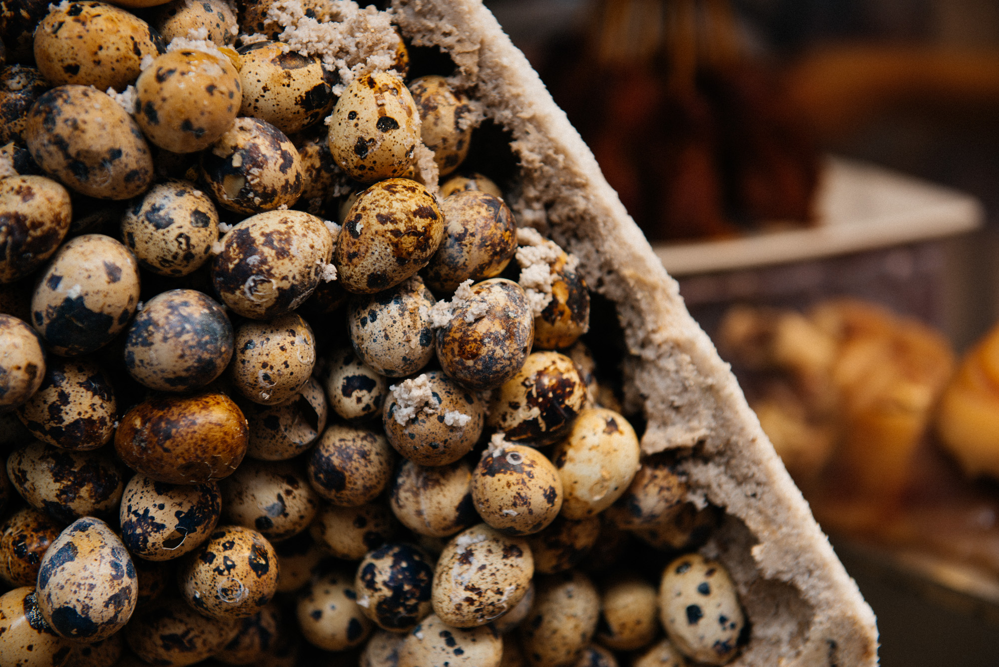 One interesting xiaochi (snack) I had never seen are these eggs. There are hundreds of quail eggs piled up with some goose eggs in the middle and then cemented together with some kind of sugar or salt. They then heat it up from the bottom to cook it and break it open from the side and sell the individual eggs.