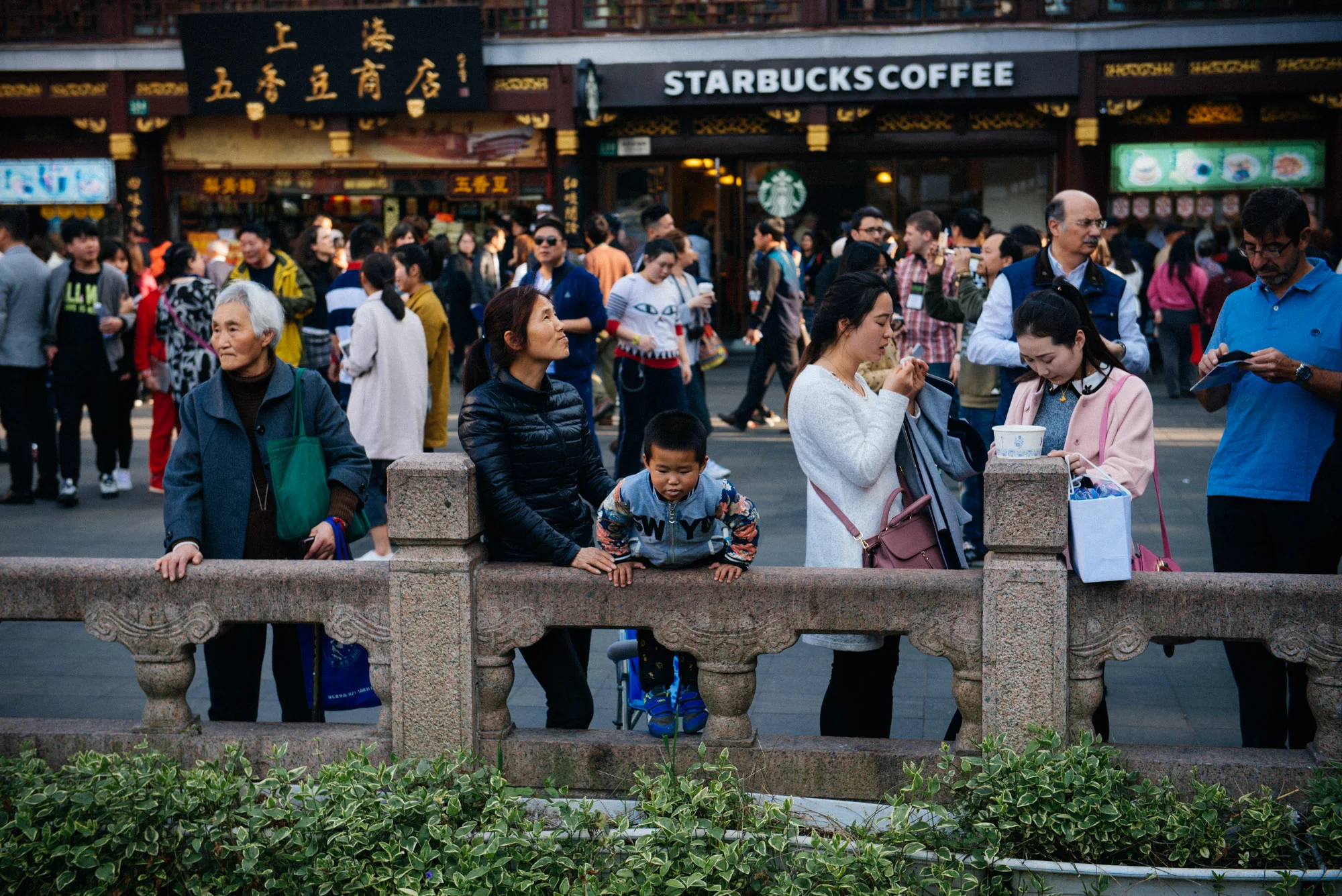 Right in front of the Starbucks, hundreds of tourists wander like ants and one little boy keeps trying to launch himself into the water while his mom incessantly held him down.