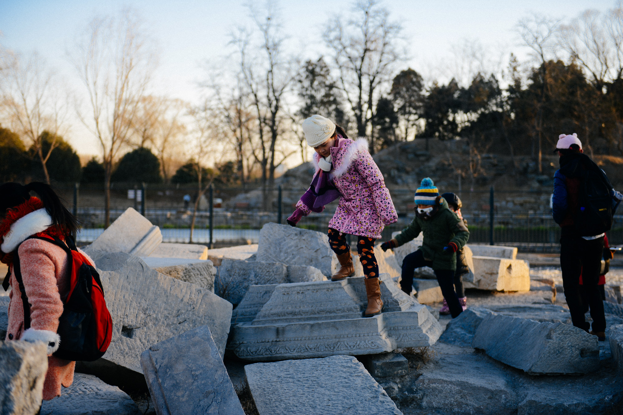 Students walk over the ruins of one of the European style buildings. These stones seemed like marble to me.