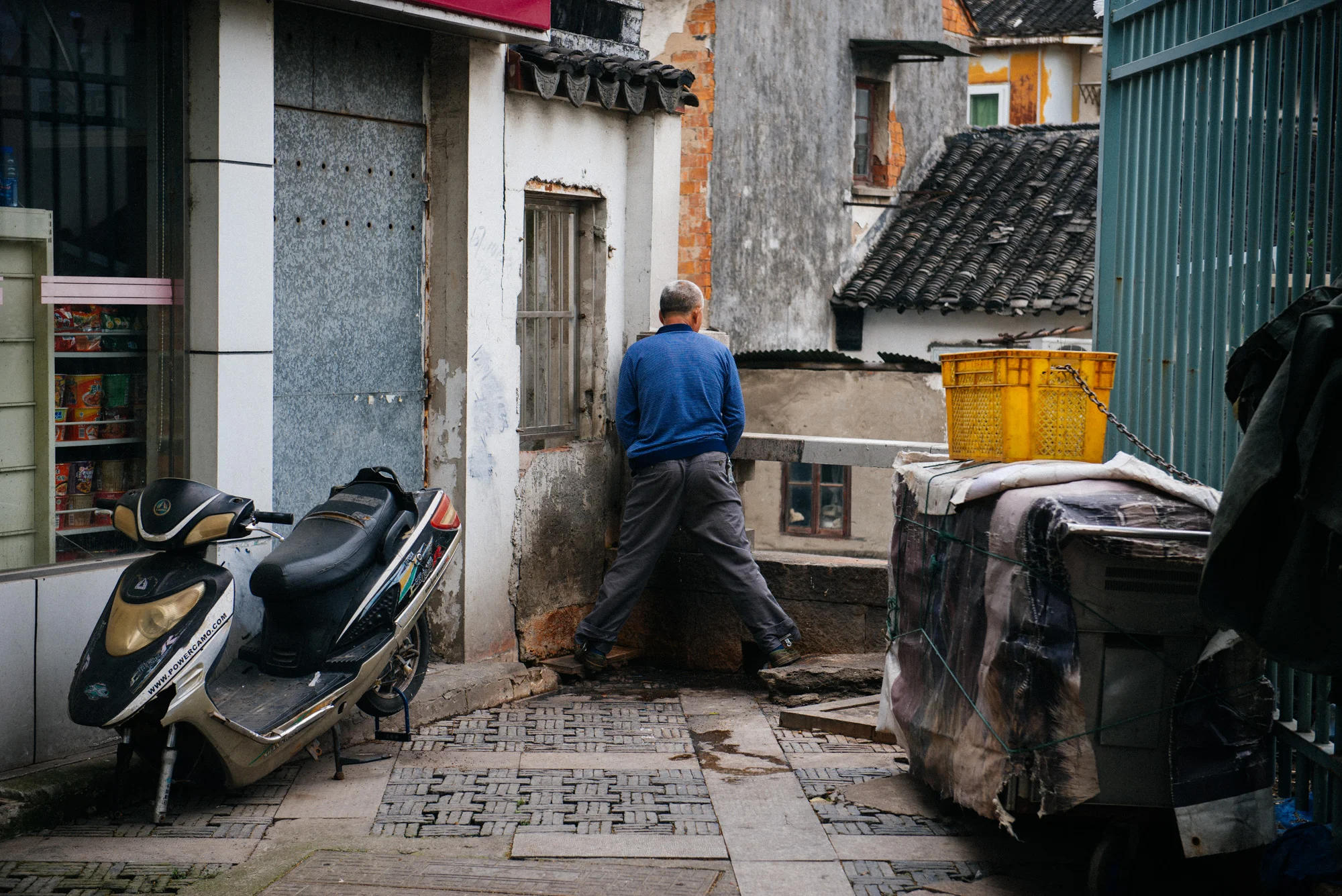 Man urinates in a corner in plain view of a huge avenue. Unfortunately, this is more common than I would like.