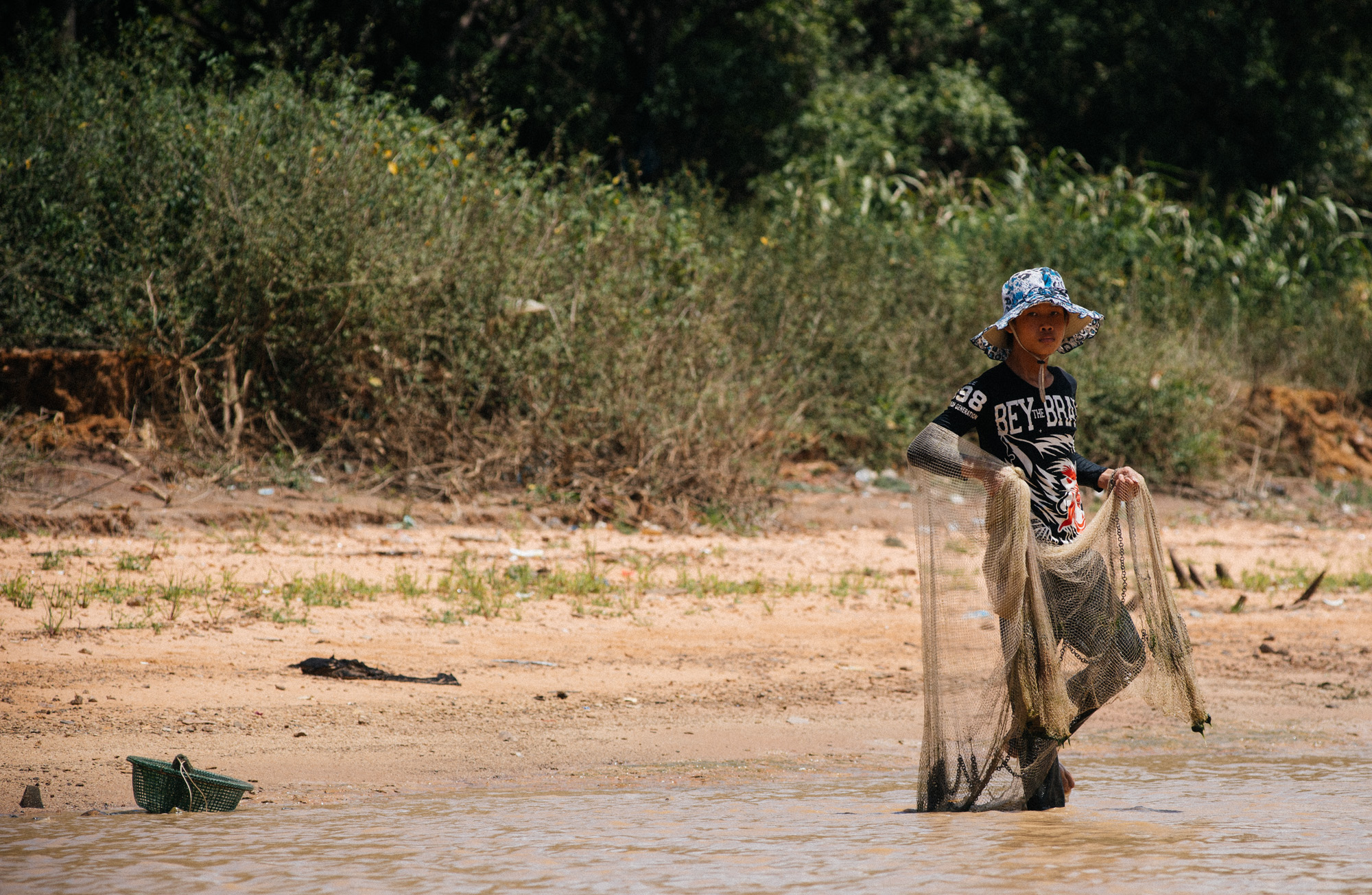 Fisherman tries to catch some fish to sell at the market.