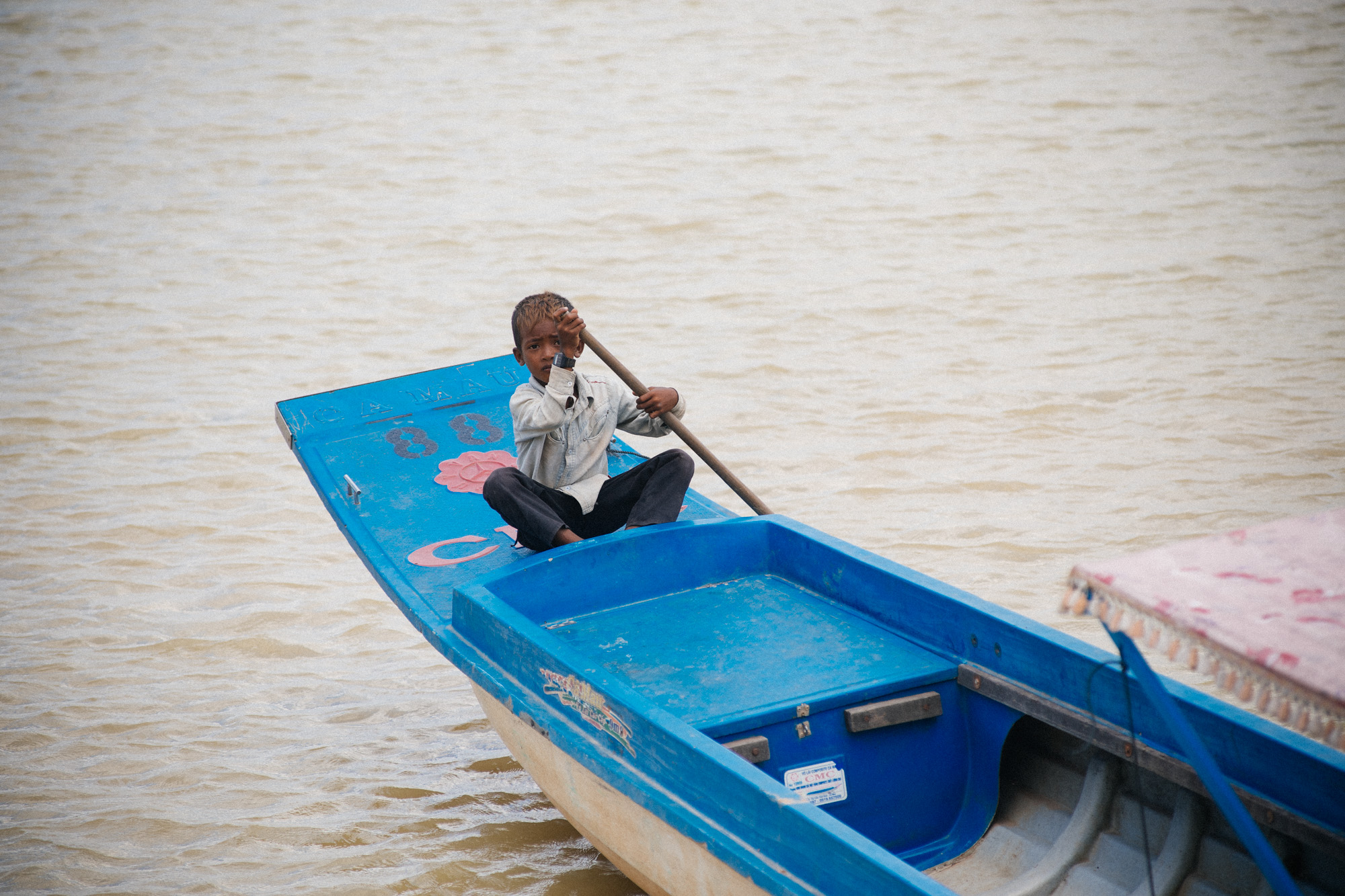 Boy plays at the docks on one the tourist boats.